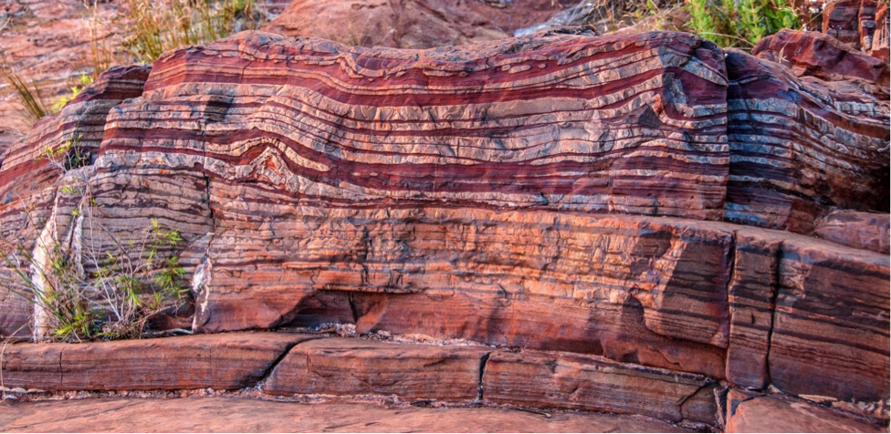 Figure 6.14 Banded iron formation (red) interbedded with chert (white), Dales Gorge, Australia [By Dales Goge by Graeme Churchard under CC BY 2.0.