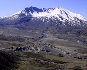 Figure 4.11 The north side of Mt. St. Helens in southwestern Washington State, 2003 [SE photo]. The large 1980 eruption reduced the height of the volcano by 400 m, and a sector collapse removed a large part of the northern flank. Between 1980 and 1986 the slow eruption of more mafic and less viscous lava led to construction of a dome inside the crater.